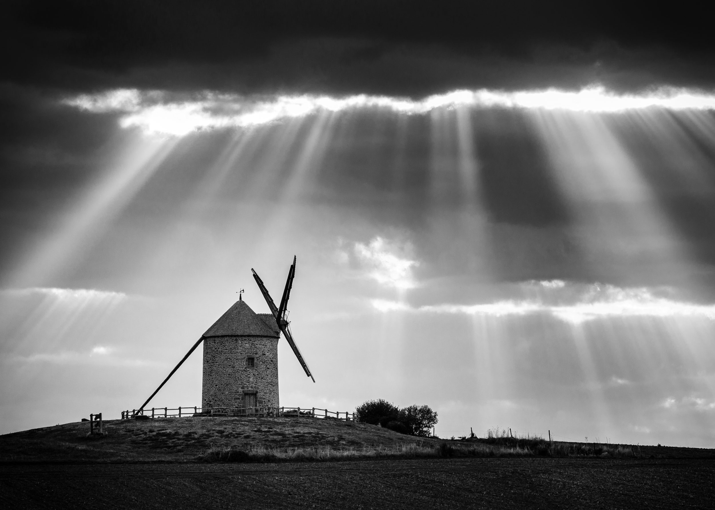 After taking some photos of this nice windmill in the stunning early morning light just after sunrise, I was patient enough to hang around for a while. After an hour or so the sun climbed and these gorgeous sunbeams cracked the sky and clouds.