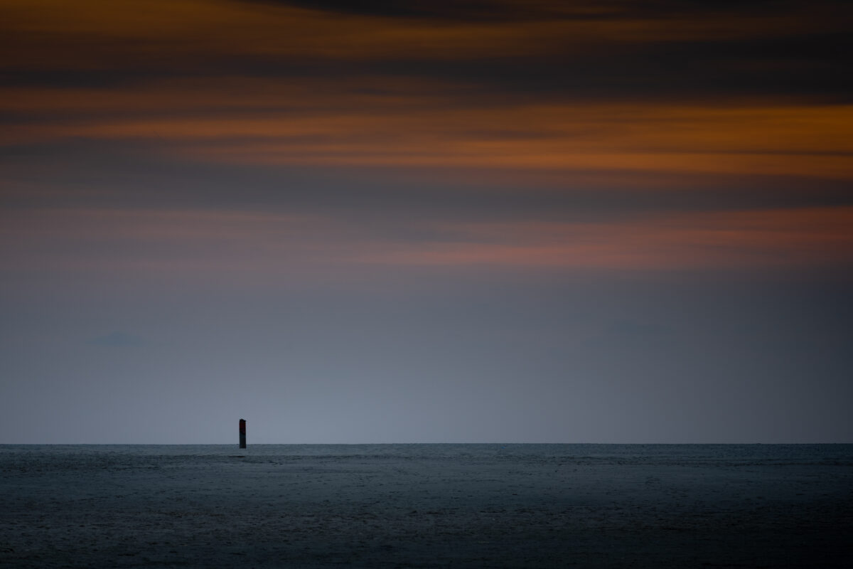Lone beach pole during sunset